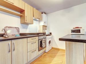 a kitchen with a sink and a stove top oven at 14 Red Rock Apartments in Dawlish Warren