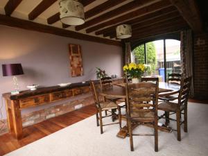 a dining room with a wooden table and chairs at Spring Farm Barn in Grindale