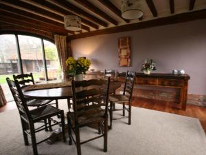 a dining room with a table and chairs at Spring Farm Barn in Grindale