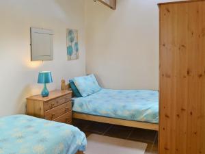 a bedroom with two twin beds and a dresser at Padgett Lodge - 23052 in Folkton