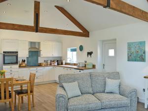 a kitchen and living room with a couch and a table at The Dairy Uk13198 in Butterwick +17 photos