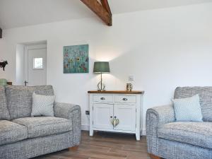 a living room with two chairs and a table at The Dairy Uk13198 in Butterwick
