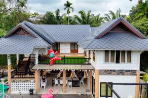 a house with a doll sitting on the porch at Avita Pool Villa in Sichon +61 photos