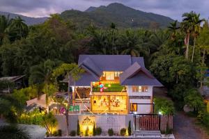 an aerial view of a house at night at Avita Pool Villa in Sichon