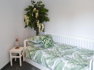 a bedroom with a bed with a plant on it at Bertram Cottage in Swarland