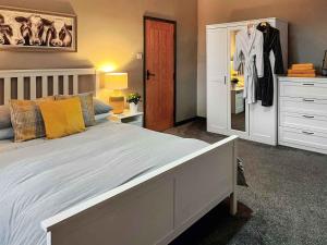 a bedroom with a large bed and a closet at Bertram Cottage in Swarland