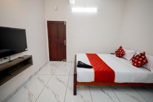 a bedroom with a bed and a flat screen tv at Royal La Casa in Cochin