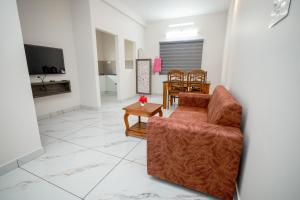 a living room with a couch and a table at Royal La Casa in Cochin