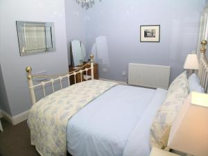 a small bedroom with a bed and a mirror at Ted's House in Mytholmroyd