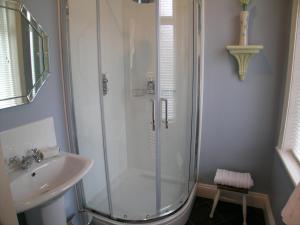 a bathroom with a shower and a sink at Ted's House in Mytholmroyd +5 photos