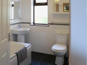 a bathroom with a toilet and a sink at Deo Na Mara in Midtown Brae +2 photos