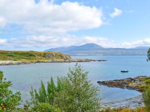 a large body of water with a boat in it at Port Righ Cottage in Carradale