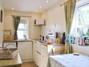 a kitchen with a sink and a counter top at Port Righ Cottage in Carradale