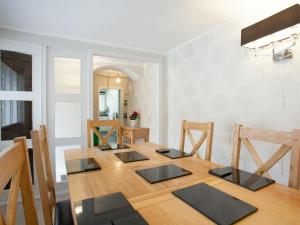 a dining room with a wooden table and chairs at Strone Farm House in Torcastle