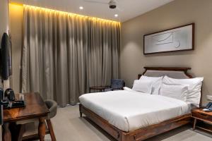 a bedroom with a bed and a desk with a computer at KMR Hotels & Resorts in Bikaner +39 photos