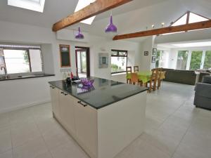 a kitchen with a large island in a living room at Dornock Brow Cottage in Dornock
