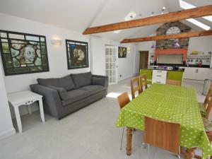 a living room with a table and a couch at Dornock Brow Cottage in Dornock