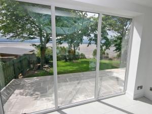 a large window in a house looking out onto a patio at Dornock Brow Cottage in Dornock +12 photos