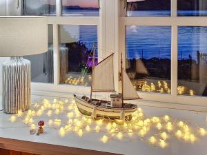 a toy boat sitting on a table with lights at Sanctuary Cottage in Applecross
