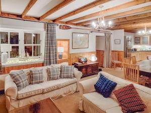 a living room with two couches and a dining room at Sanctuary Cottage in Applecross
