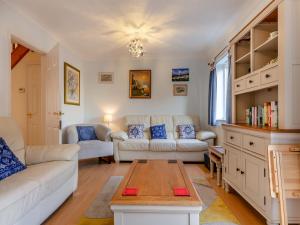 a living room with a couch and a table at Chaucer Rise in Exmouth