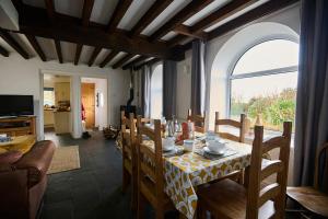 a dining room with a table and chairs and a window at Granary - Ukc4684 in Clynnog-fawr