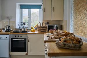 a kitchen with a counter with a basket of bread at Granary - Ukc4684 in Clynnog-fawr