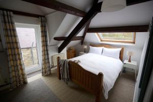 a bedroom with a bed and a window at Granary - Ukc4684 in Clynnog-fawr +6 photos