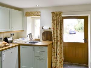 a kitchen with a sink and a window at The Smithy in Ovingham