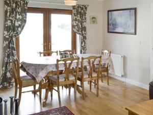 a dining room with a table and chairs at Heatherlea in Otterburn
