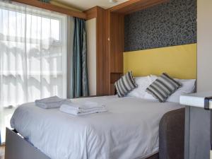 a bedroom with a white bed with towels on it at Valley View - Uk50320 in Liskeard