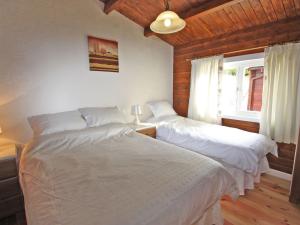a bedroom with two beds and a window at White Springs - Lake View in Llanedy