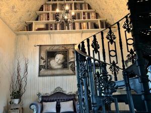 a staircase with a picture of a child on the wall at Silverleaf Cottage in Rye