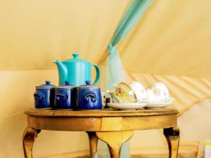 a table with blue vases and plates on it at Moroccan - Ukc5930 in Highclere