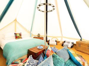 a room with a bed and pillows in a tent at Moroccan - Ukc5930 in Highclere +12 photos