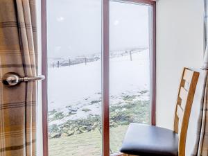 a window with a view of a snow covered field at Shepherd's Nook - Uk32388 in Dunford Bridge