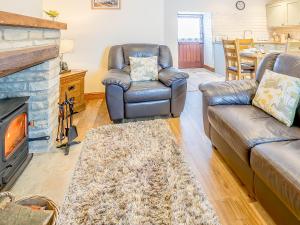 a living room with a couch and chairs and a fireplace at Shepherd's Nook - Uk32388 in Dunford Bridge