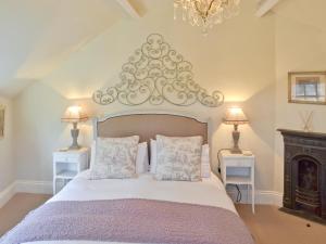 a bedroom with a large bed with two night stands at The Old Cobblers Cottage in Bakewell