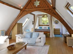 a living room with a white couch and a bed at St John The Baptist in Capel Curig
