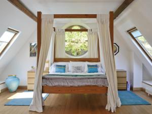a bedroom with a bed with a window at St John The Baptist in Capel Curig