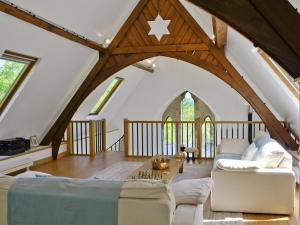 an attic living room with a vaulted ceiling at St John The Baptist in Capel Curig