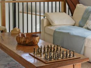 a chessboard on a table in a living room at St John The Baptist in Capel Curig +14 photos