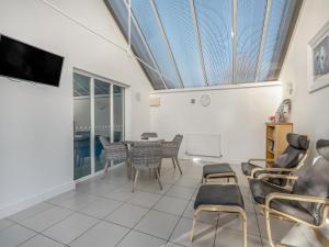 a living room with a table and chairs at The Beeches in Sea Palling