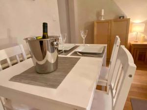 a bottle of wine in a bucket on a table at Heather Cottage in Lauder