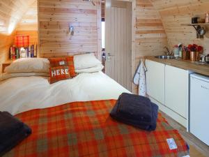 a bedroom with a bed in a log cabin at Here - Uk50566 in Port of Menteith