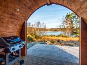 an arched doorway to a backyard with a grill at Here - Uk50566 in Port of Menteith +2 photos
