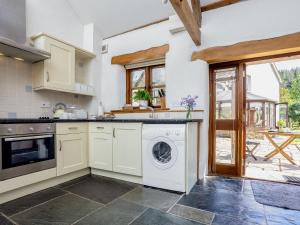 a kitchen with a washer and dryer at Old Dairy in Chulmleigh