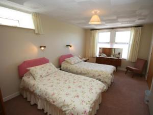 a hotel room with two beds and a mirror at Halliday Hill Cottage in Dalton