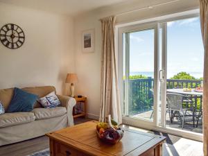 a living room with a couch and a table at Seaview Cottage - Uk44707 in Amroth