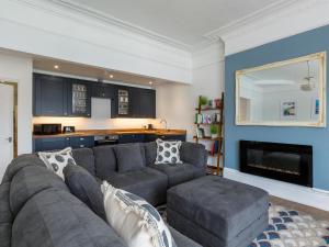 a living room with a gray couch and a fireplace at Anchorage View in Dartmouth +5 photos